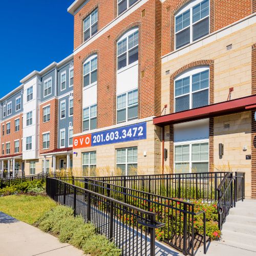 Exterior view of building entrance and sidewalk 	