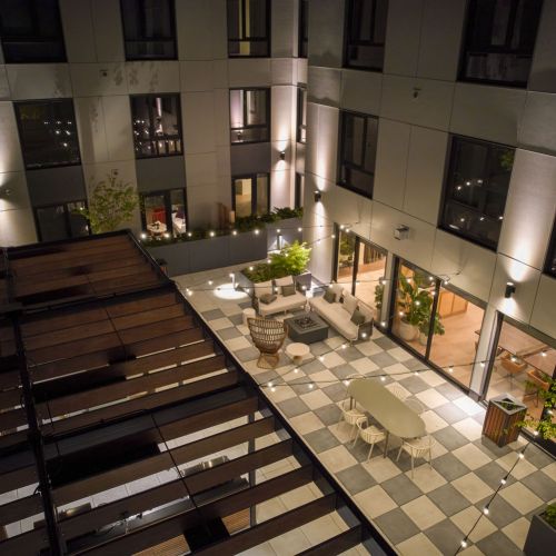 Outdoor terrace lit by string lights	