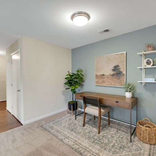 Front door to living room with home office space