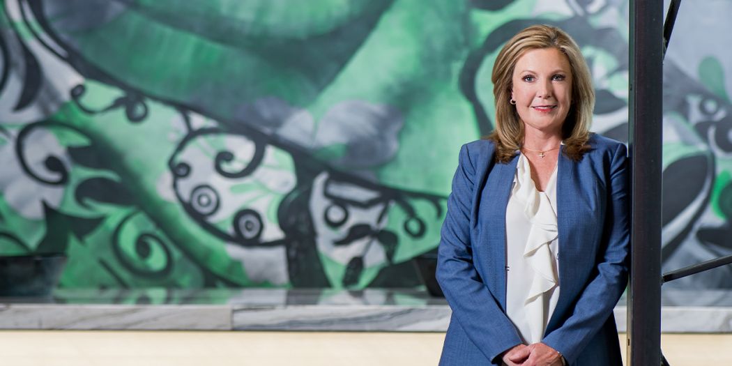 Bozzuto's Julie Smith in front of a mural