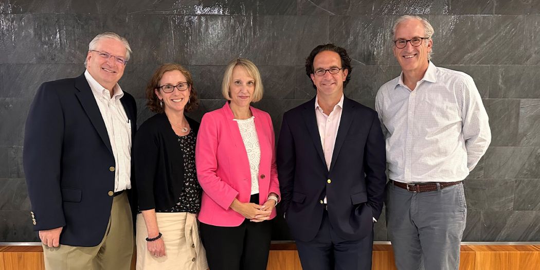 Kirsten Andrews Woelper poses with four members of Bozzuto's leadership team