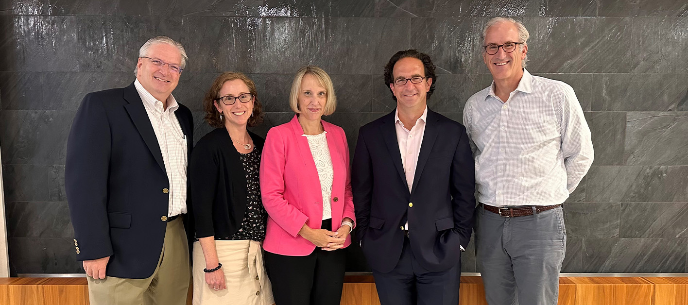 Kirsten Andrews Woelper poses with four members of Bozzuto's leadership team