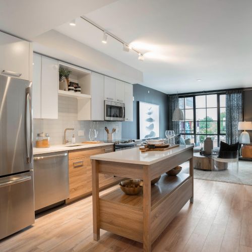 Kitchen with island and view of living room