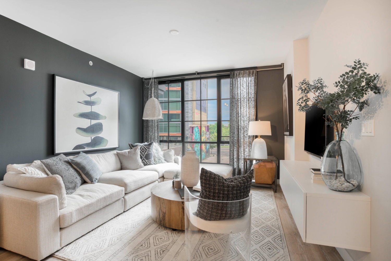 Living room with large couch and floor-to-ceiling windows 