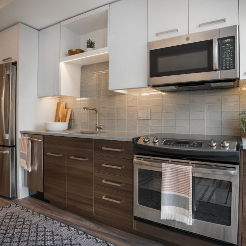 Kitchen with dark cabinets and stainless steel appliances