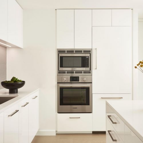 White kitchen featuring stainless steel appliances 