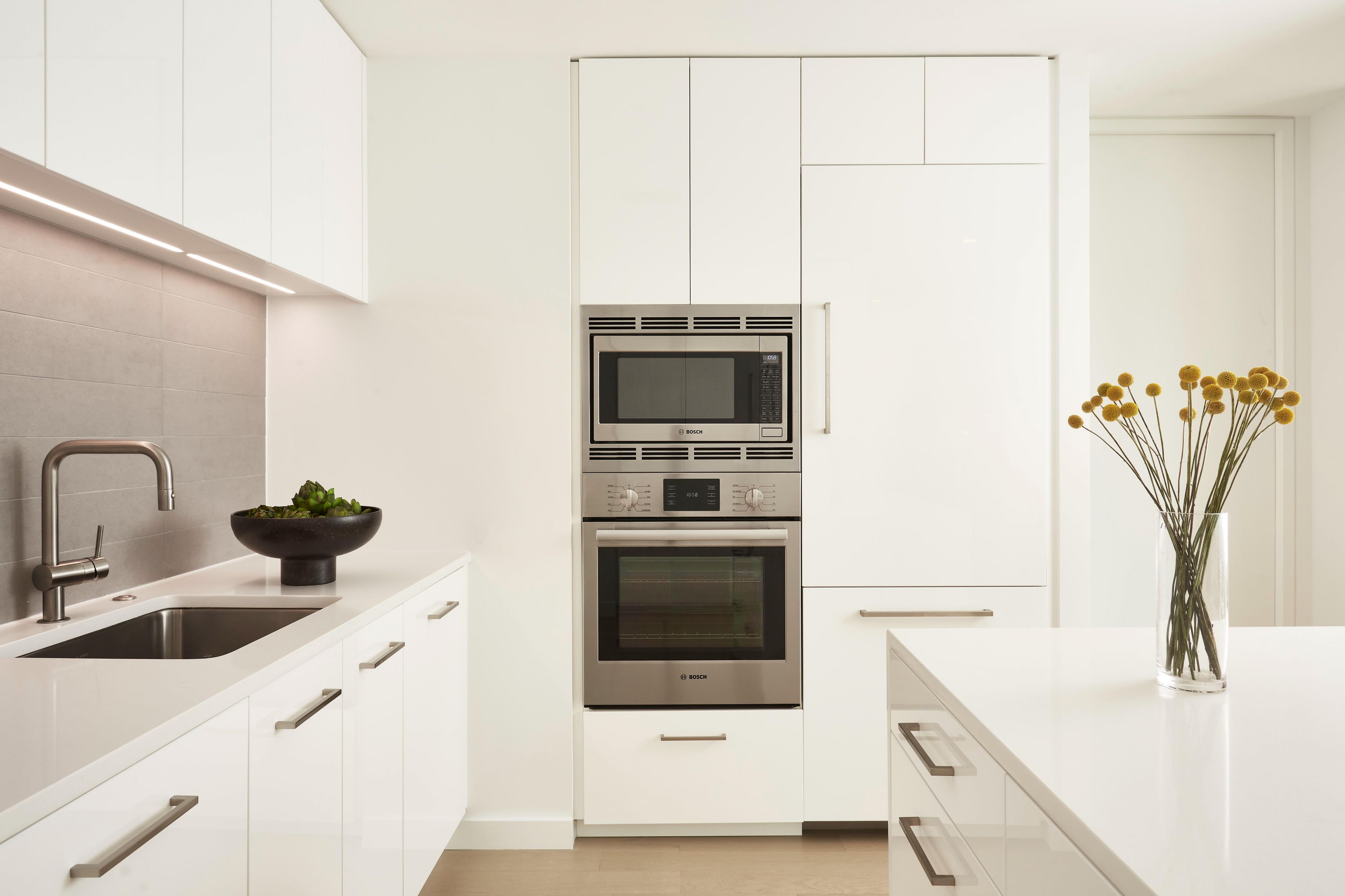 White kitchen featuring stainless steel appliances 