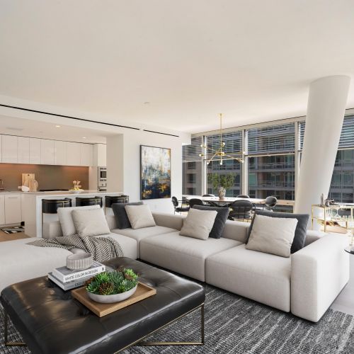 Spacious apartment living room showing kitchen