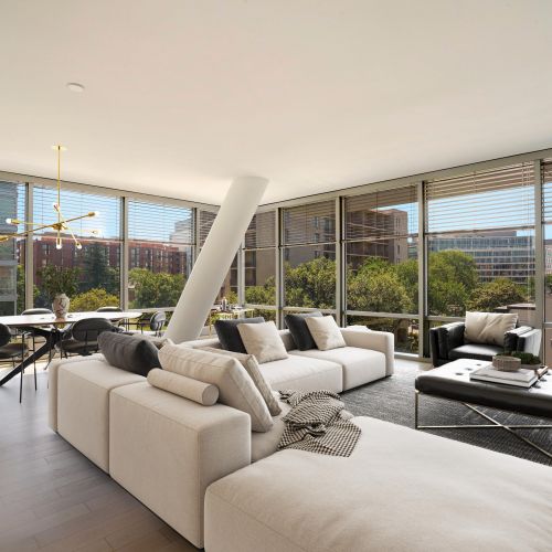 Apartment living room with expansive couch and dining