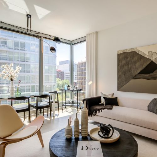 Apartment living room lined with floor-to-ceiling windows