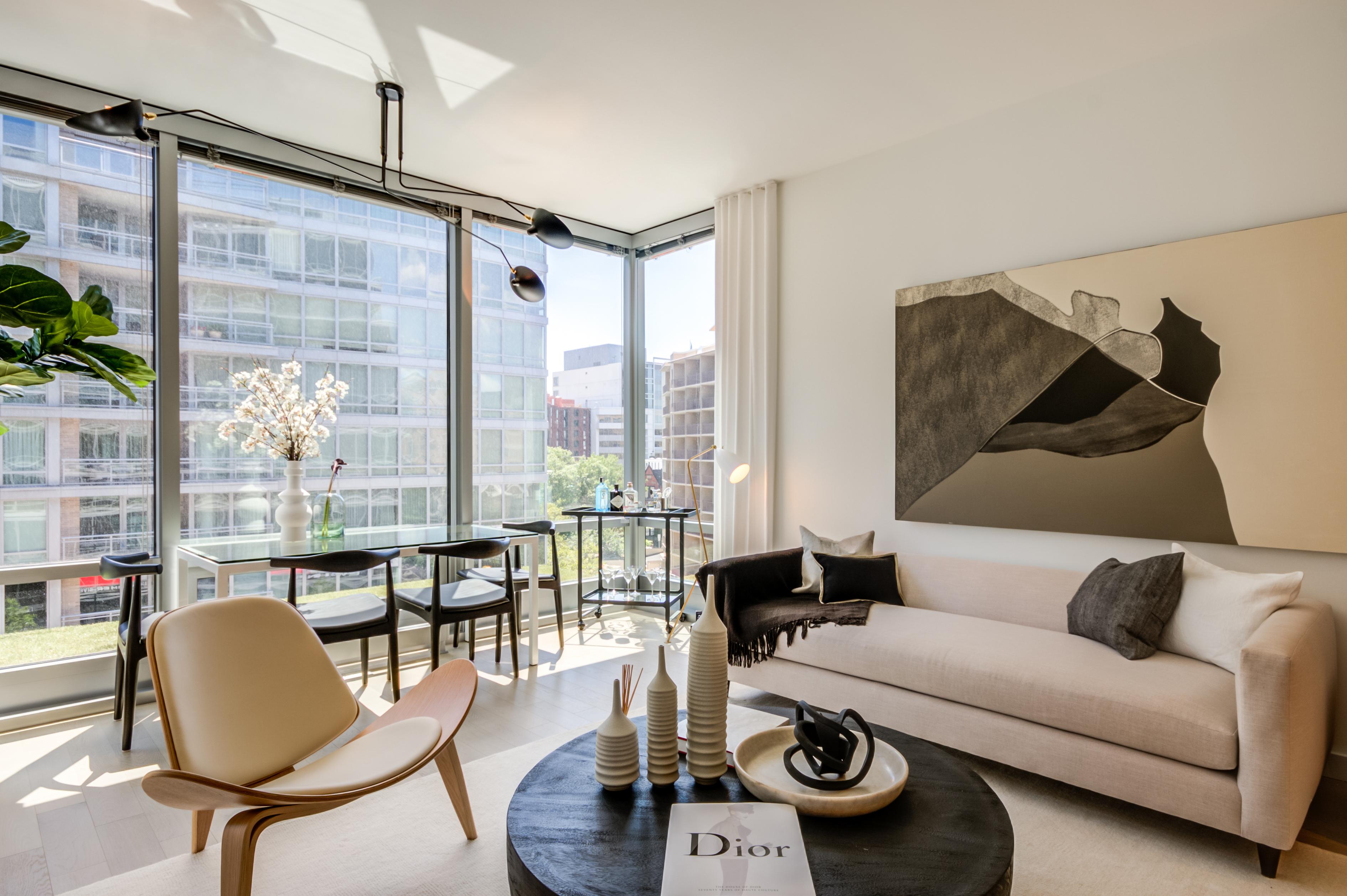 Apartment living room lined with floor-to-ceiling windows