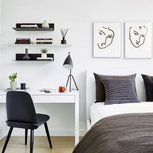 Decorated bedroom with desk and bed