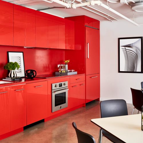Vibrant red amenity kitchen with seating 