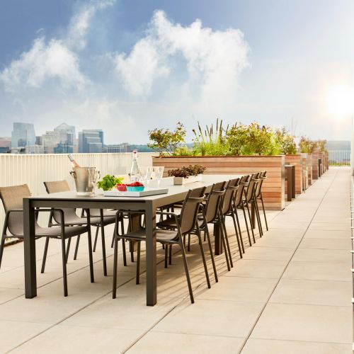 Large dining table on rooftop with city views 