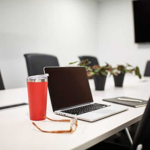 Laptop on large table in a meeting room 