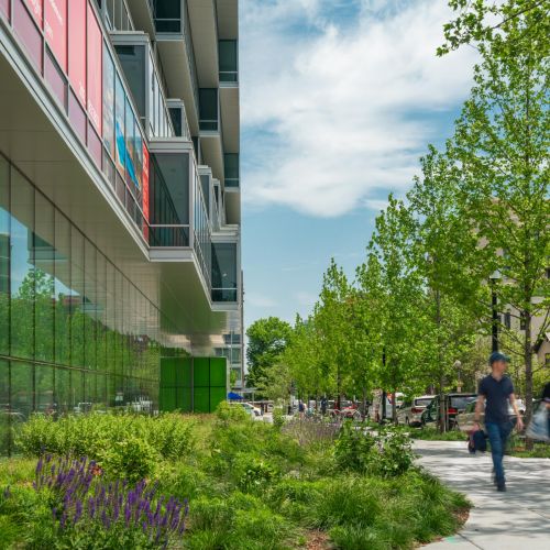 View of ground level exterior with people walking on sidewalk 