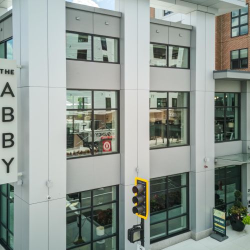 The Abby landmark sign with a captivating corner view of the neighborhood.	
