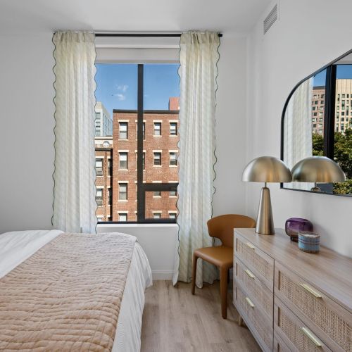Bright primary bedroom with natural light.