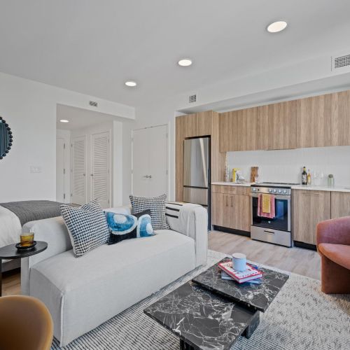 Studio layout integrating living, bed, and kitchen spaces.