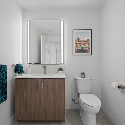 Studio bathroom vanity with a lit mirror.