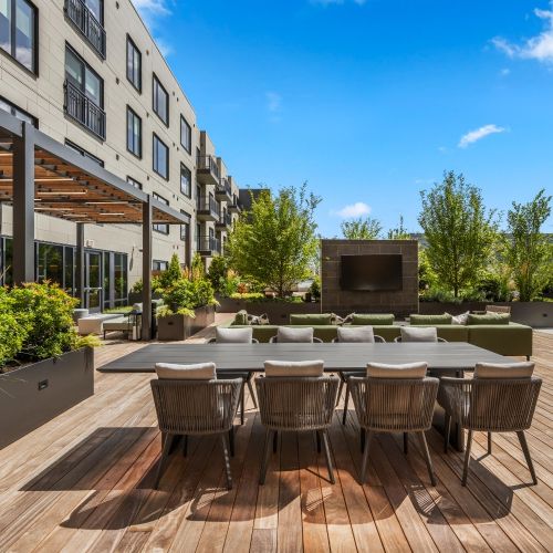 Enjoy friendly competition and socializing at our rooftop deck's bag toss area, complete with communal seating.