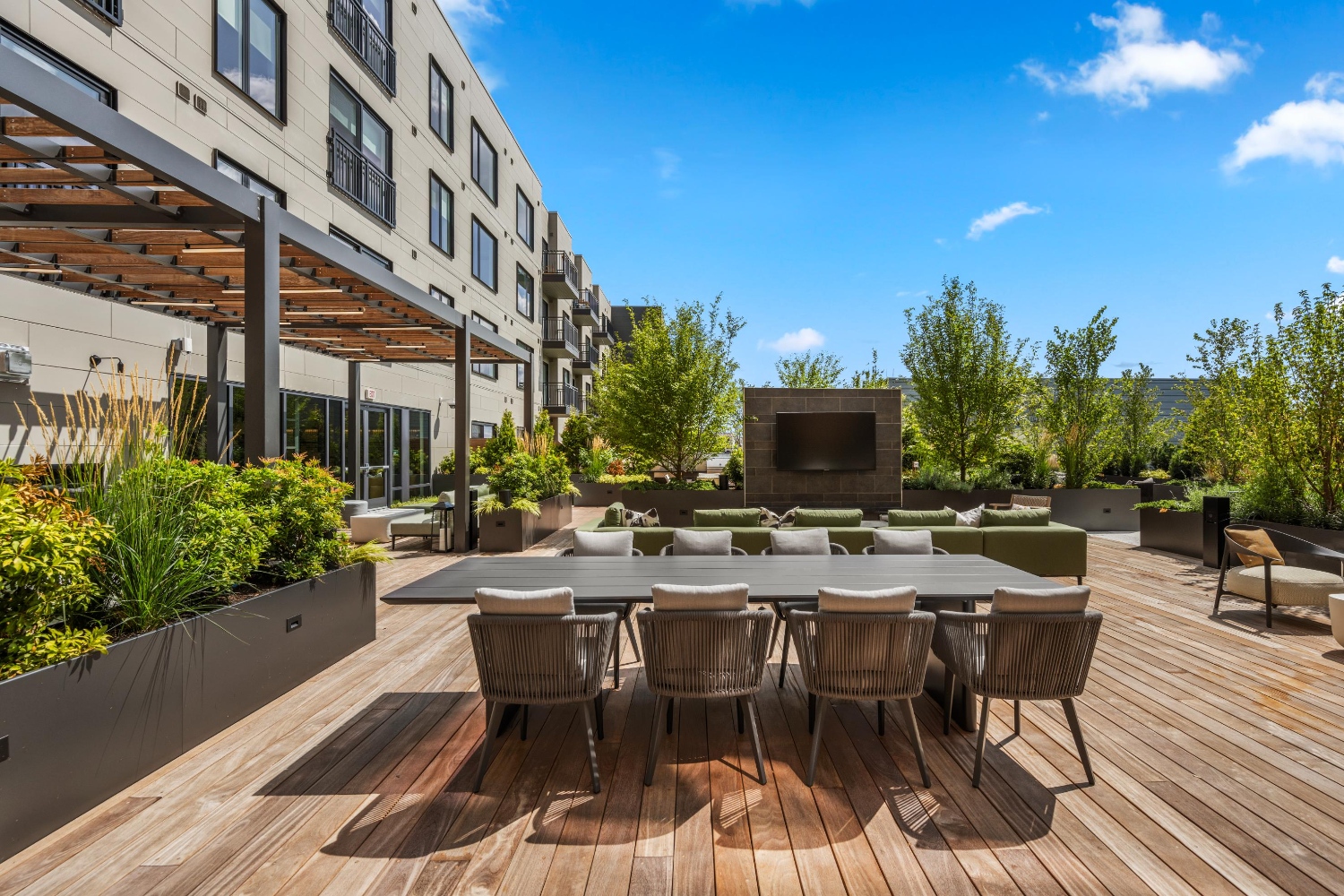 Alder at Allston Yards : Enjoy friendly competition and socializing at our rooftop deck's bag toss area, complete with communal seating.