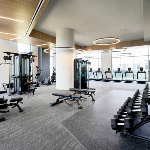 Large fitness center with designated yoga and spin room, outdoor yoga deck, and fitness lounge.