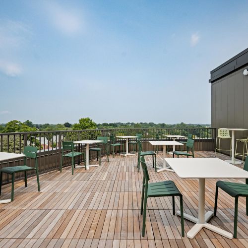 Rooftop seating area with bag toss game.	