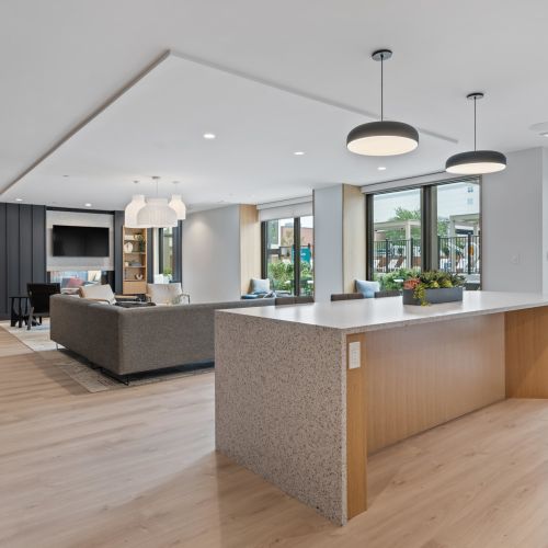 Lounge with sectional and community kitchen.	