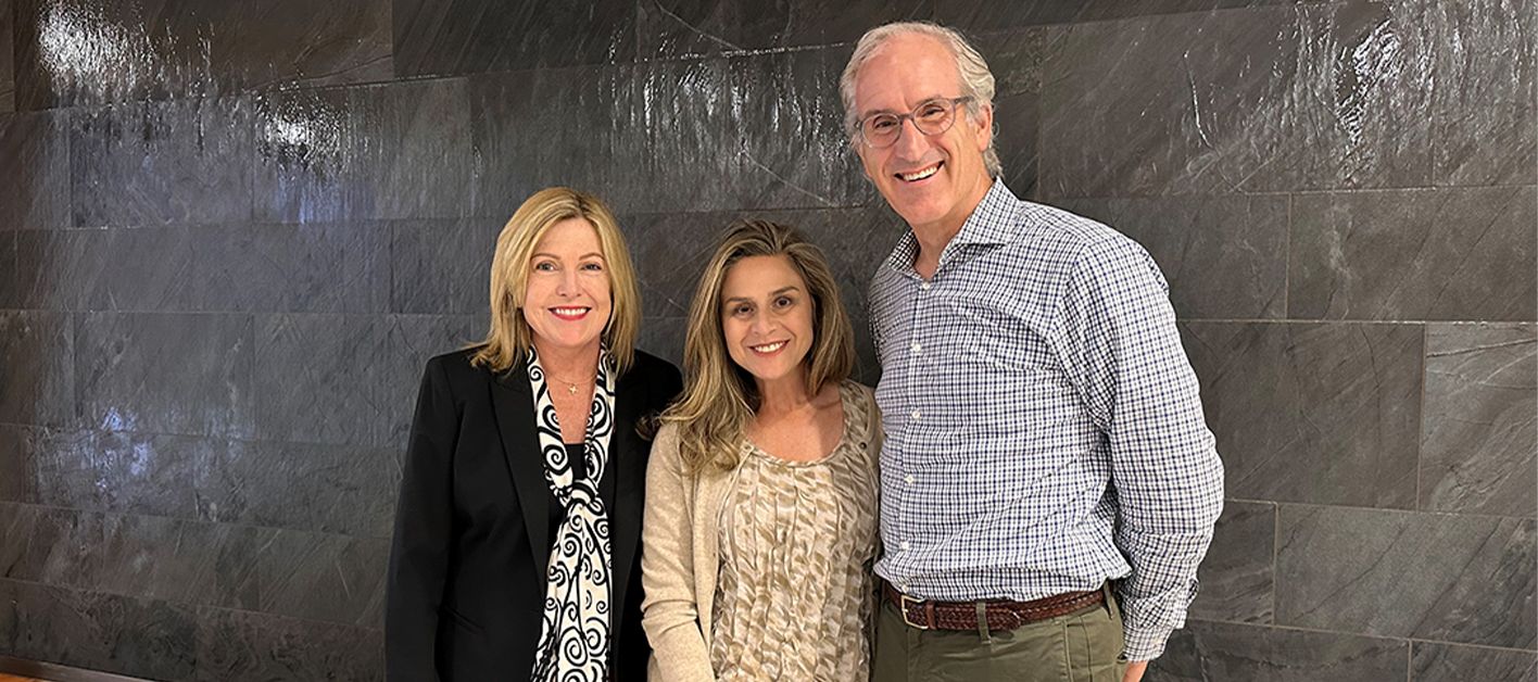 Lauren Fitzgerald poses with two members of Bozzuto's leadership team