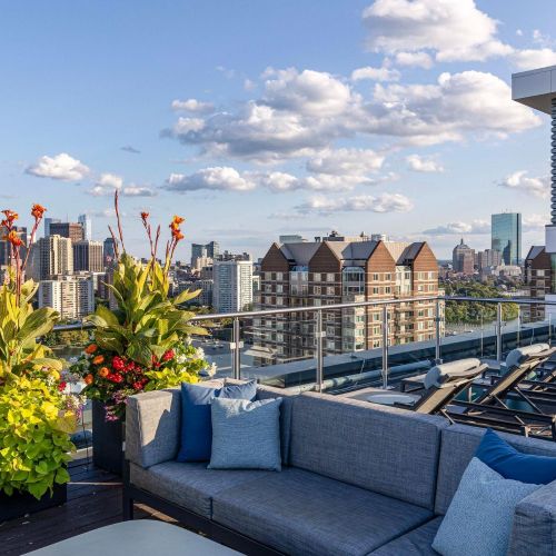 Rooftop deck lounge seating with city view, third angle.