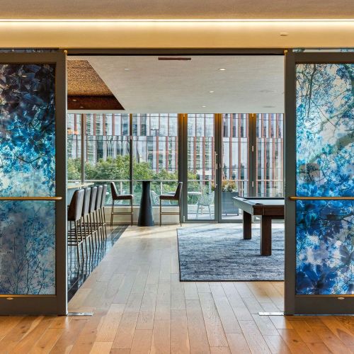 Rooftop lounge with pool table and bar.