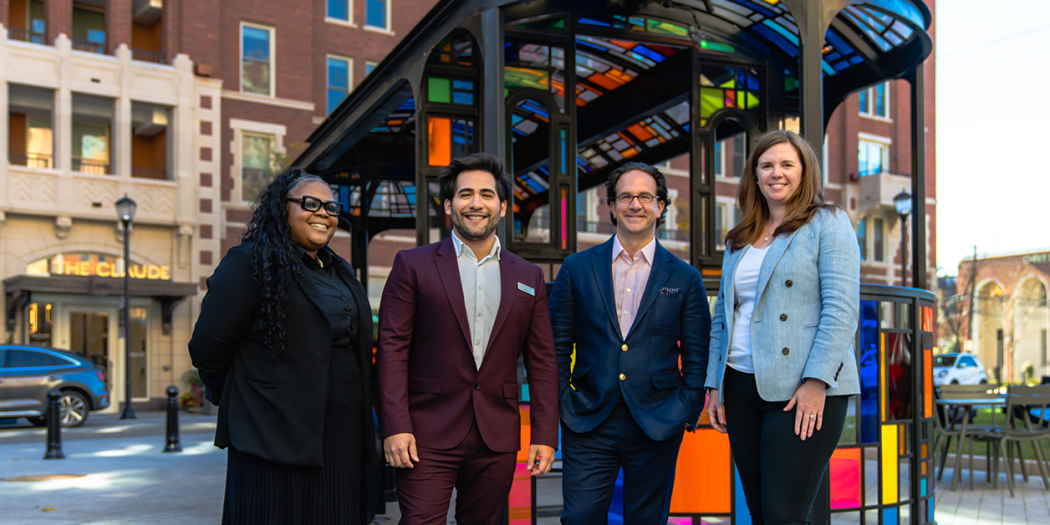 CEO Toby Bozzuto standing with three Bozzurto individuals at a bus stop
