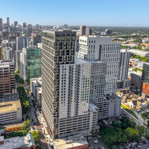 High-rise apartment towers in downtown cityscape with skyline and blue sky background