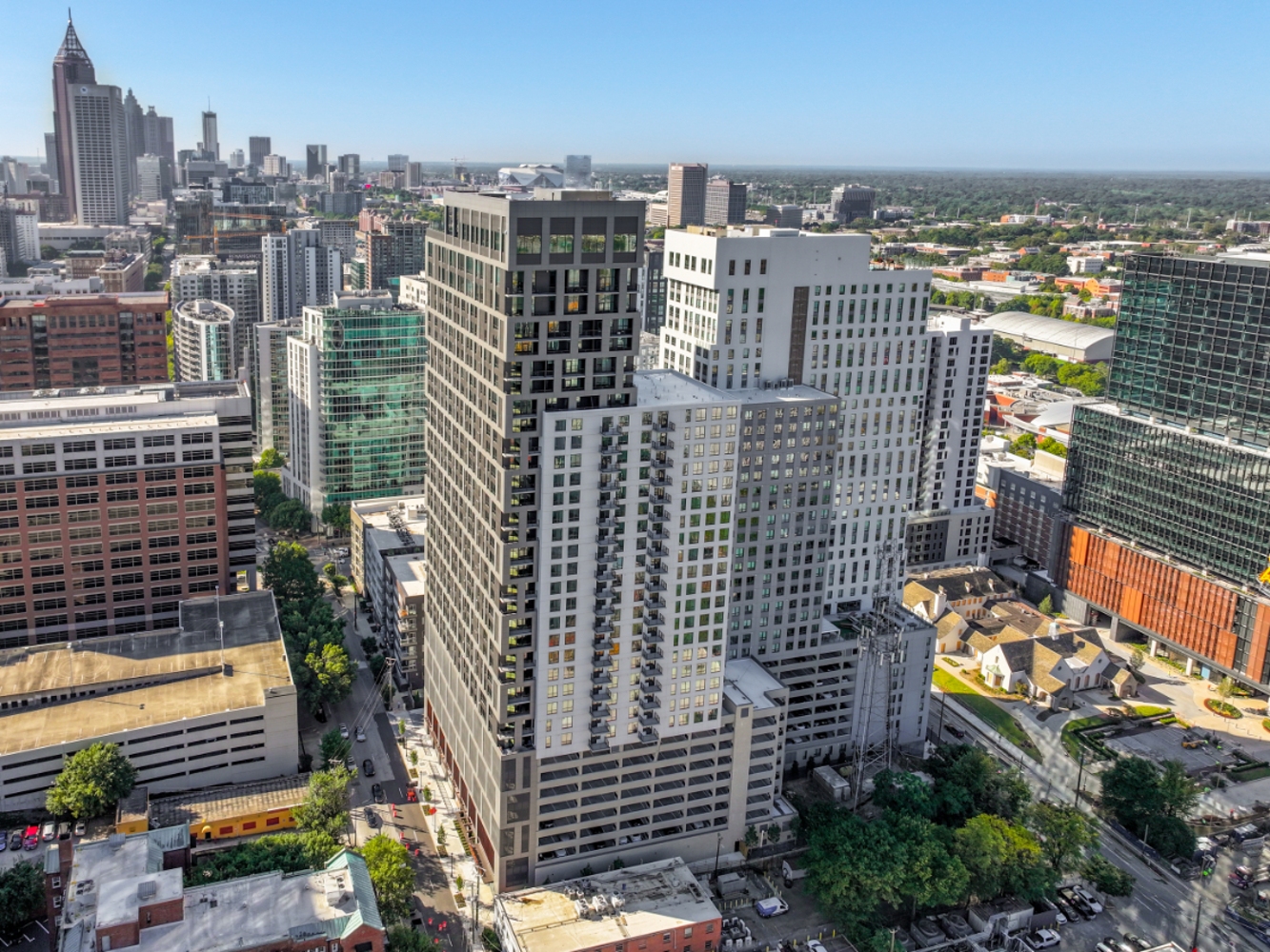 High-rise apartment towers in downtown cityscape with skyline and blue sky background