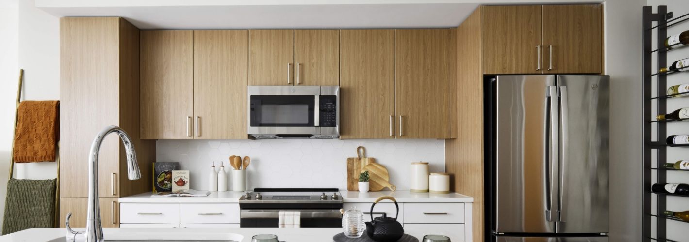 Oakville : With two-tone kitchen cabinets in wood grain and white with hexagonal white tile backsplash	