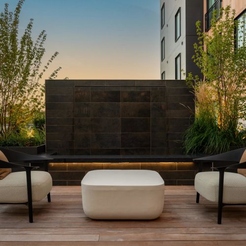 The serene sounds of a water fountain set against the vibrant hues of a sunset in the courtyard.	