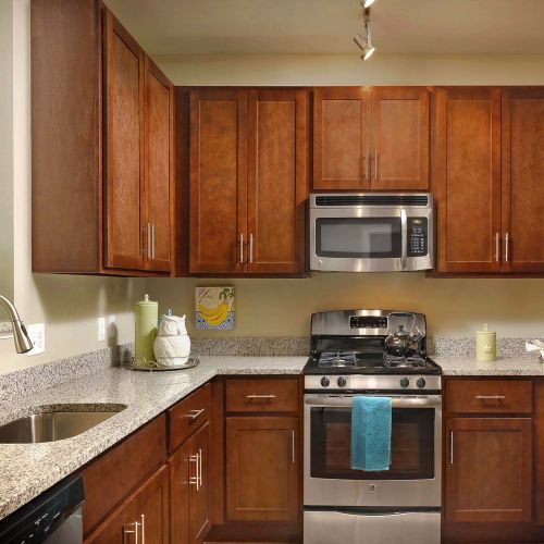 A chef's dream kitchen awaits with shaker-style cabinets, a stainless steel appliance package, and granite countertops.	