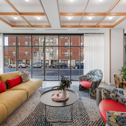 Stylish and welcoming lounge with a pop of color.	