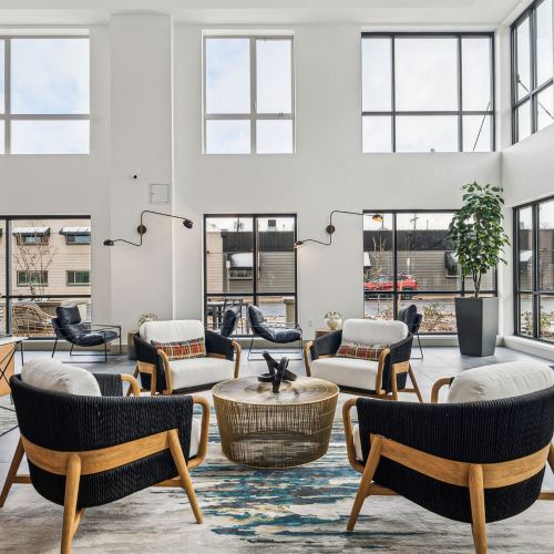 Stylish lounge seating, sleek finishes, and abundant natural light