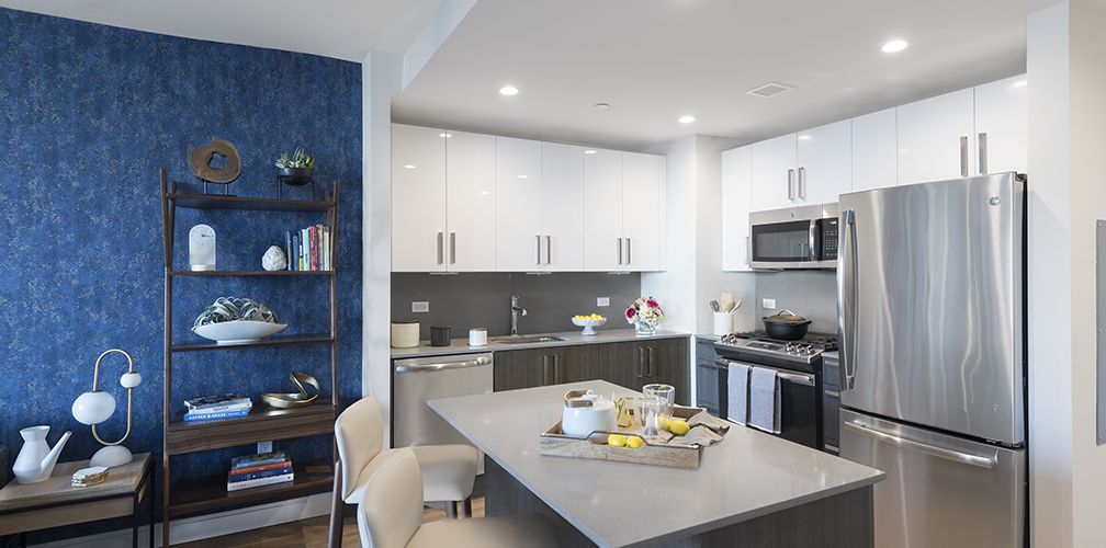 Kitchen With Metal Island and Modern Appliances 