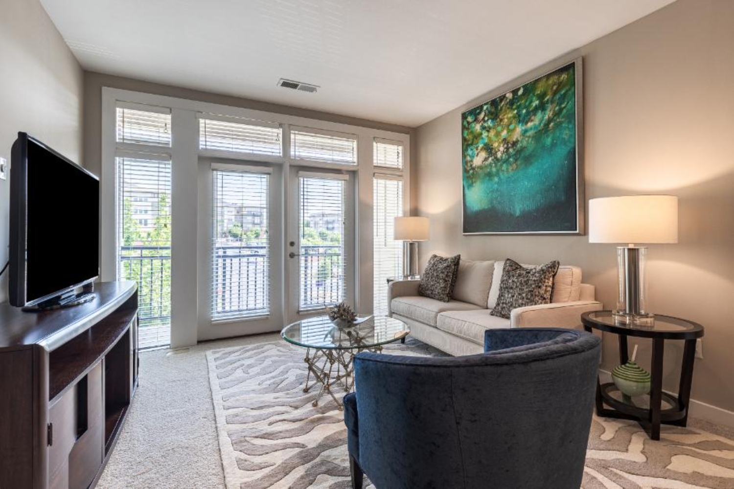 Photo of furnished living room with natural light entering through patio doors