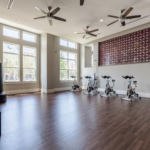 Photo of open fitness area that features bikes and other workout equipment