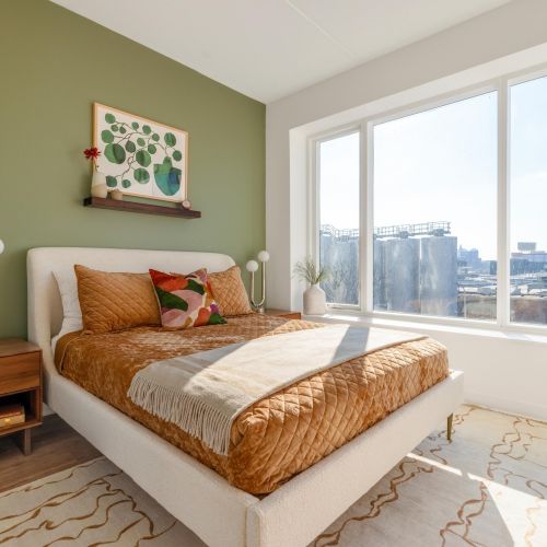Bedroom with green accent wall.