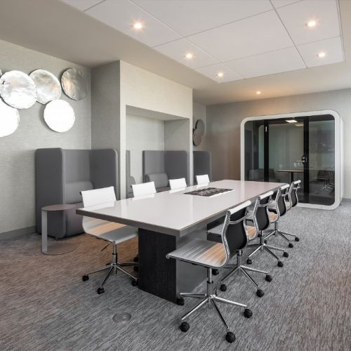 Co-working space with conference table and working pods