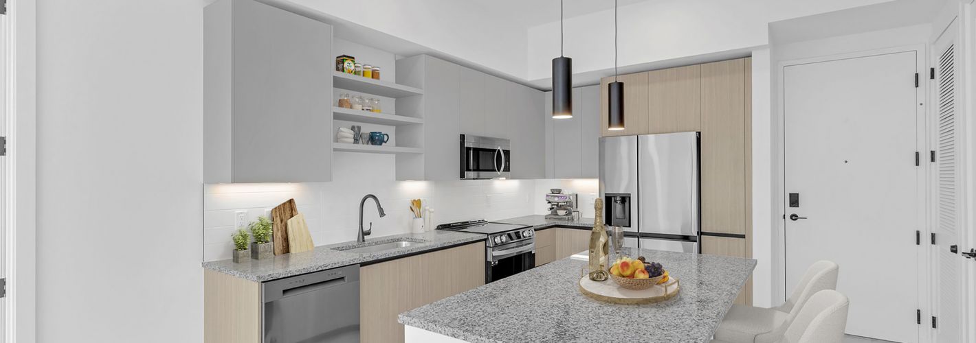 Sleek kitchens with two-tone cabinetry, granite countertops, stainless steel appliances