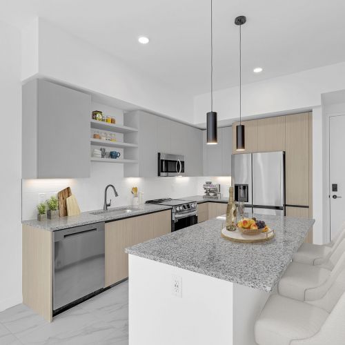 Sleek kitchens with two-tone cabinetry, granite countertops, stainless steel appliances