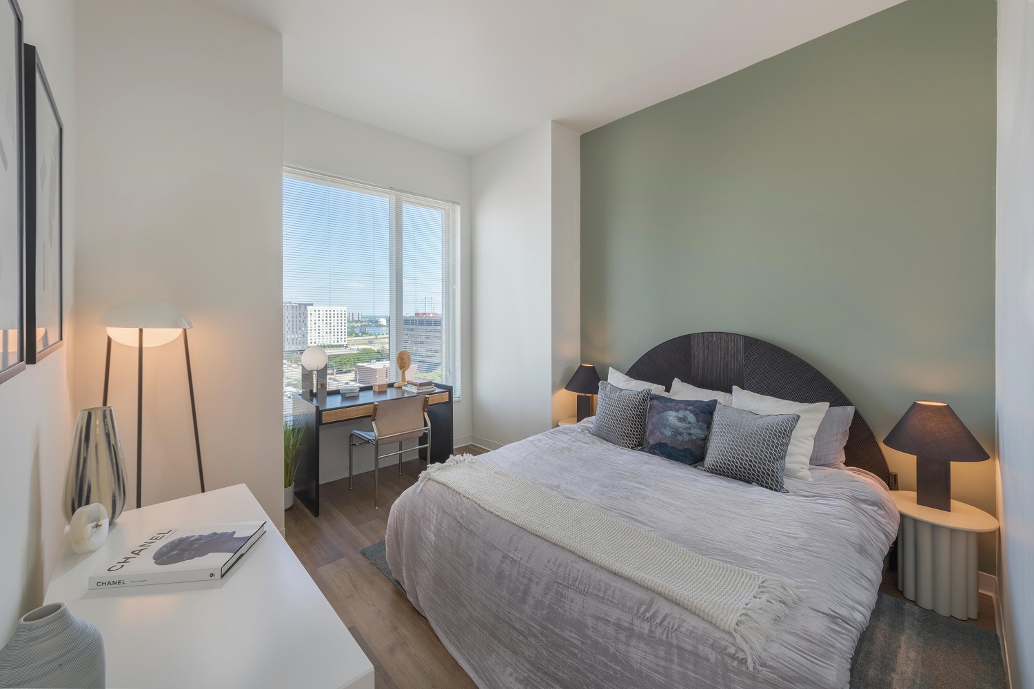 Bedroom with desk and window.