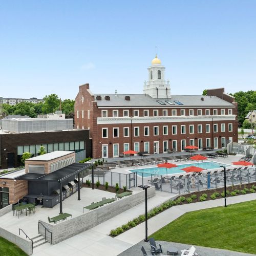 Resort-style pool paired with sleek built-in grills and lounge areas.
