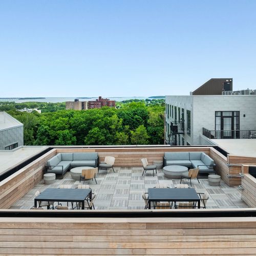 Comfortable rooftop lounge with modern sectionals and shared tables.